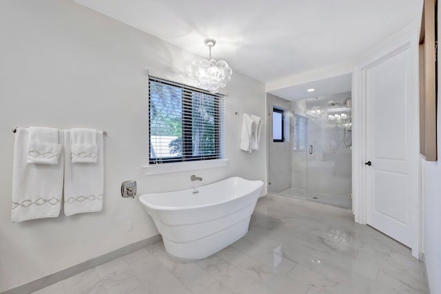 bathroom with separate shower and tub and an inviting chandelier