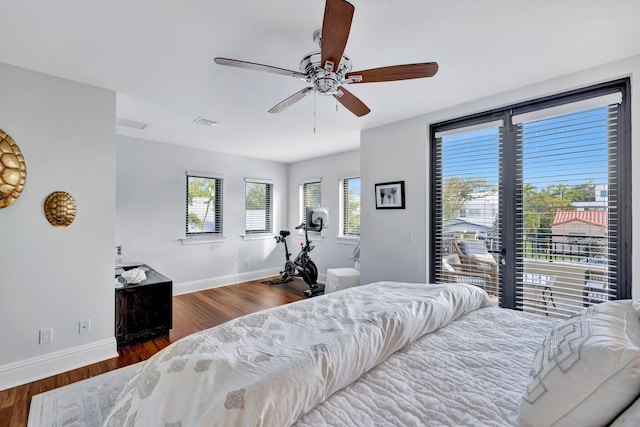 bedroom featuring dark hardwood / wood-style flooring, access to outside, and ceiling fan