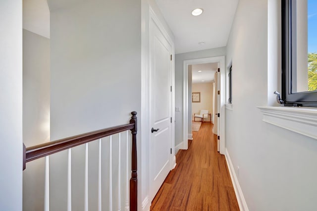 corridor with light hardwood / wood-style floors