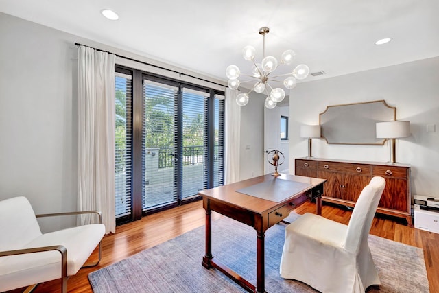 office area featuring a notable chandelier and light hardwood / wood-style flooring