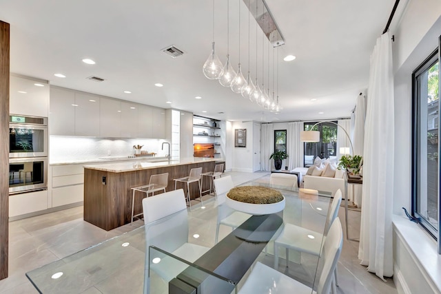 tiled dining area featuring sink