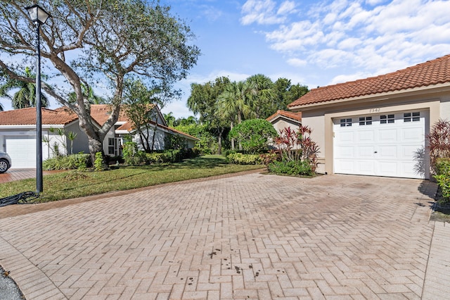 exterior space with a garage and a lawn