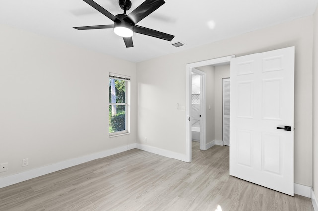 unfurnished bedroom with light hardwood / wood-style flooring, ceiling fan, and ensuite bathroom