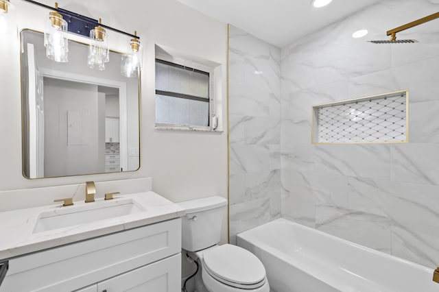 full bathroom featuring tiled shower / bath combo, vanity, and toilet