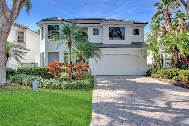 view of front of property with a garage and a front yard