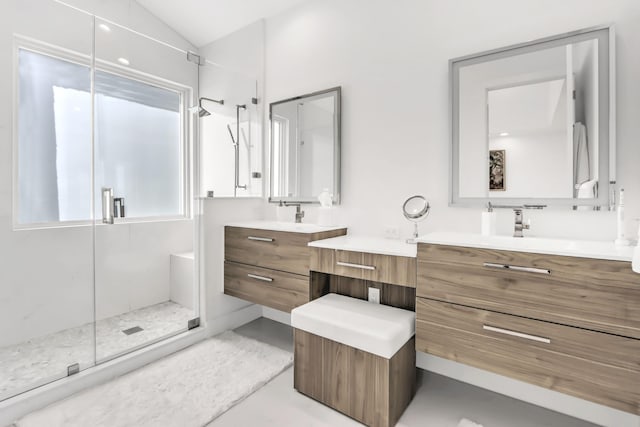 bathroom featuring vanity, lofted ceiling, and walk in shower