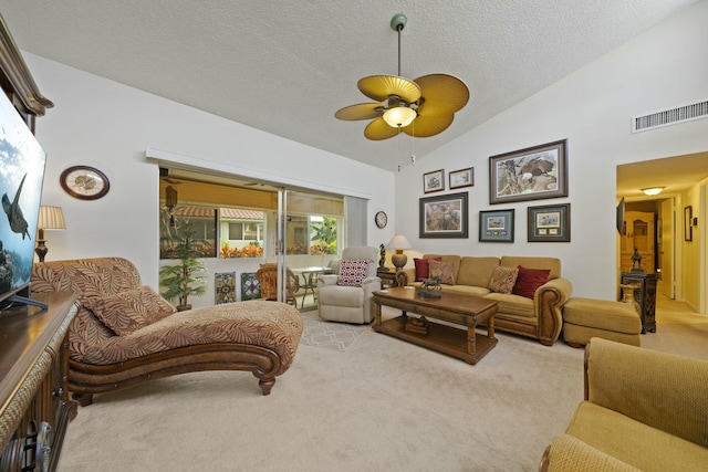 carpeted living room featuring ceiling fan, lofted ceiling, and a textured ceiling