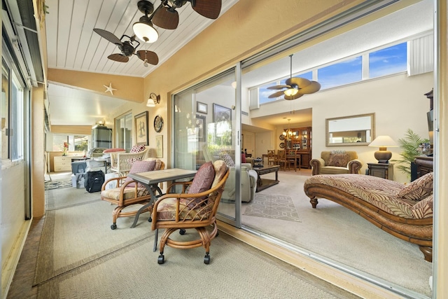 sunroom with vaulted ceiling, ceiling fan with notable chandelier, and wooden ceiling