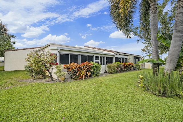 rear view of property with a yard