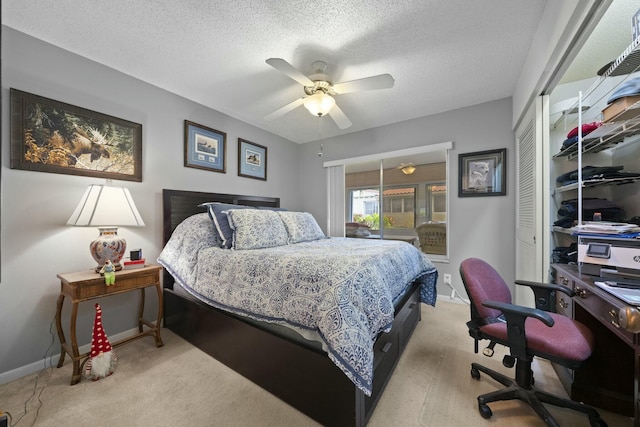 carpeted bedroom with a textured ceiling, ceiling fan, and a closet