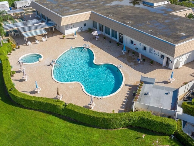 community pool featuring a community hot tub, a patio area, and a pergola