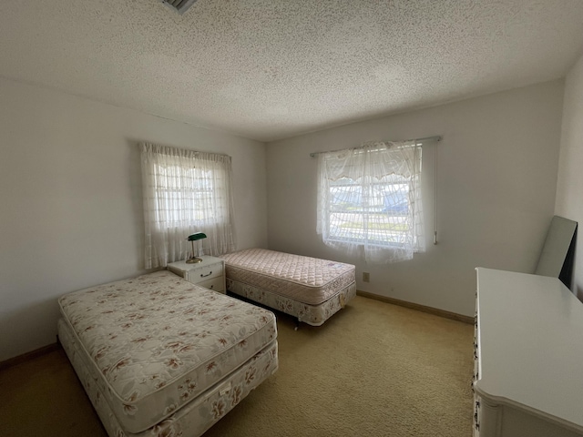 carpeted bedroom featuring a textured ceiling