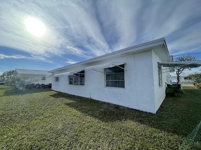 view of side of property with a yard