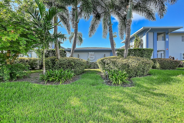 2110 NE 42nd St # 1B, Lighthouse Point, FL 33064 - view of side of home featuring a lawn and brick siding