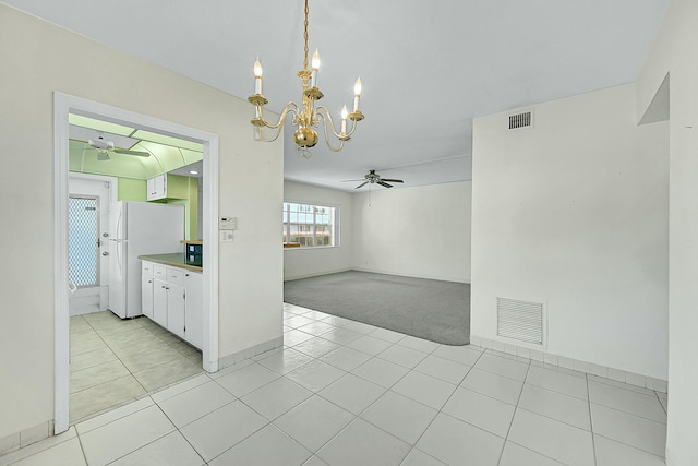 unfurnished dining area with light tile patterned floors, visible vents, and light colored carpet