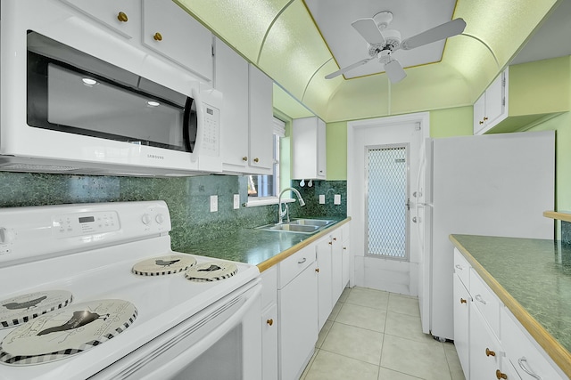 2110 NE 42nd St # 1B, Lighthouse Point, FL 33064 - kitchen with white appliances, a sink, light tile patterned floors, ceiling fan, and backsplash