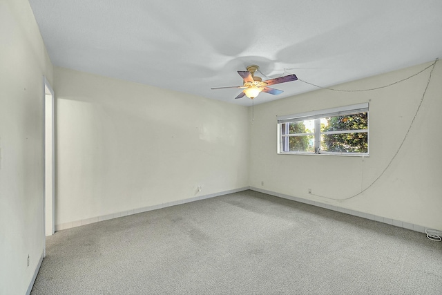 empty room with ceiling fan and carpet flooring