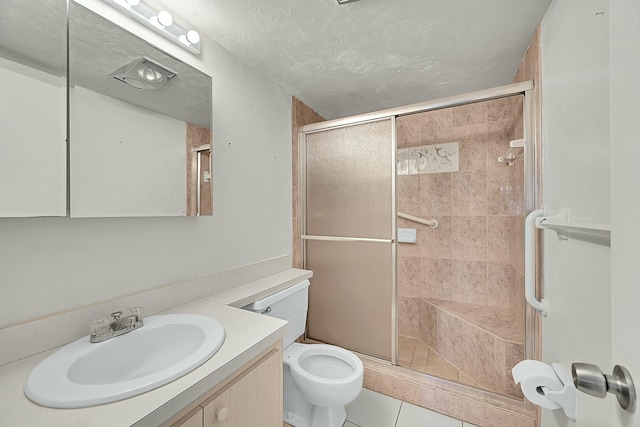 bathroom with walk in shower, vanity, tile patterned floors, and toilet