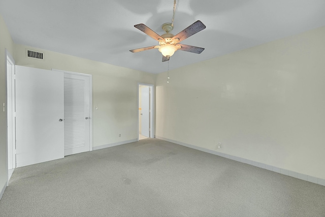 2110 NE 42nd St # 1B, Lighthouse Point, FL 33064 - unfurnished bedroom featuring light carpet, a ceiling fan, and baseboards