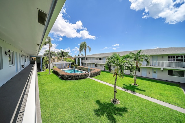 view of community featuring a lawn and a residential view