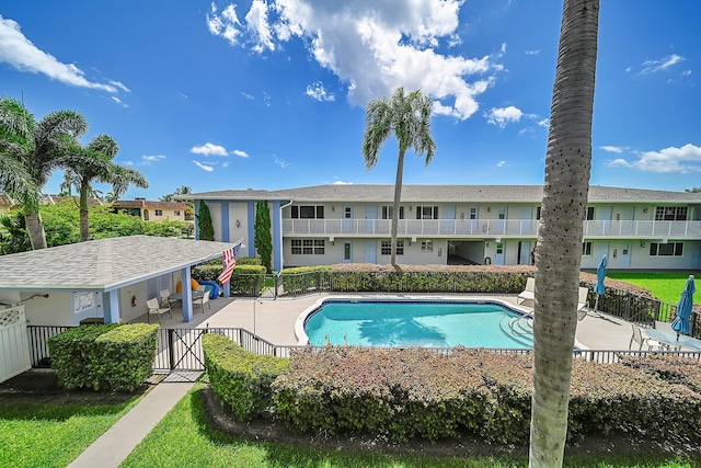 2110 NE 42nd St # 1B, Lighthouse Point, FL 33064 - community pool featuring a patio, fence, and a residential view