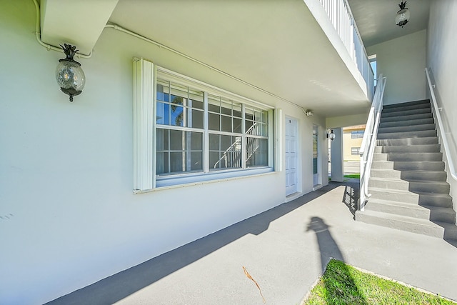 property entrance with stucco siding