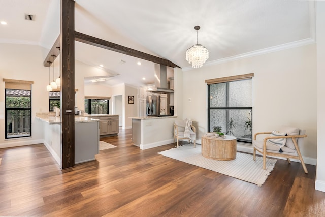 living room featuring dark hardwood / wood-style flooring, lofted ceiling with beams, and a healthy amount of sunlight