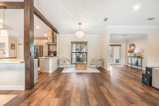 interior space with dark hardwood / wood-style flooring, crown molding, and a chandelier