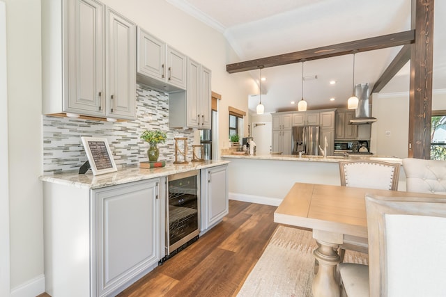 kitchen with gray cabinets, stainless steel fridge, ventilation hood, decorative light fixtures, and beverage cooler