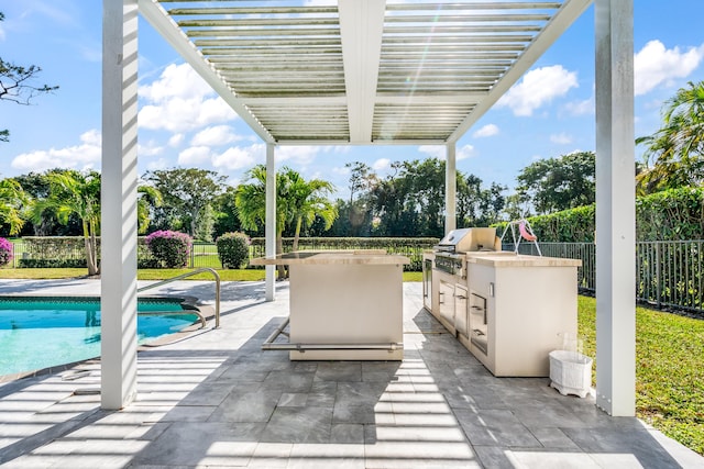 view of patio / terrace featuring an outdoor kitchen, area for grilling, exterior bar, a pergola, and a fenced in pool