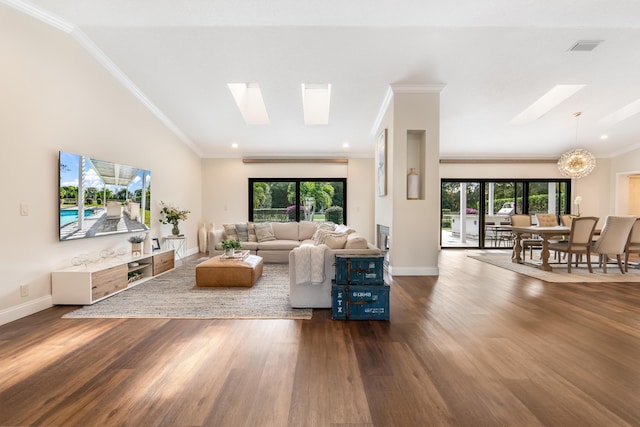 living room featuring a notable chandelier, dark wood-type flooring, and a skylight