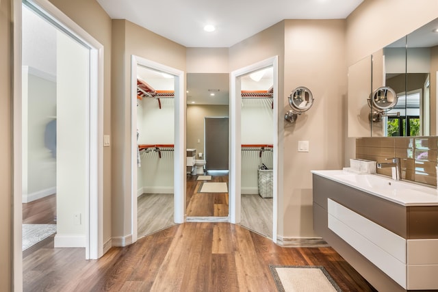 bathroom with vanity, hardwood / wood-style floors, and toilet