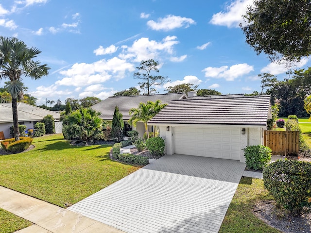 view of front of home featuring a garage and a front yard