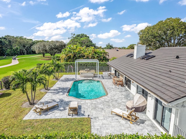 view of swimming pool featuring a yard, a pergola, and a patio area