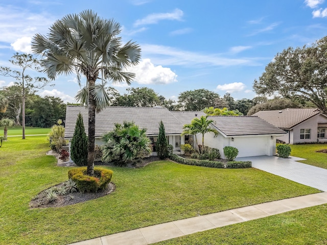 ranch-style home featuring a garage and a front yard