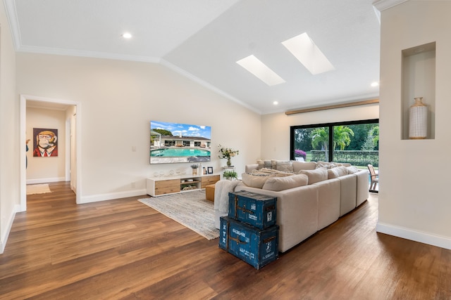 living room featuring crown molding, dark wood-type flooring, and vaulted ceiling with skylight