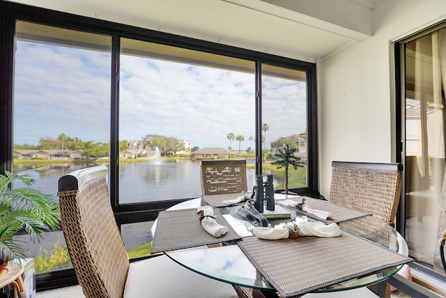 dining space featuring a water view