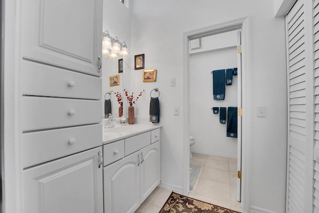 bathroom featuring tile patterned flooring, vanity, and toilet