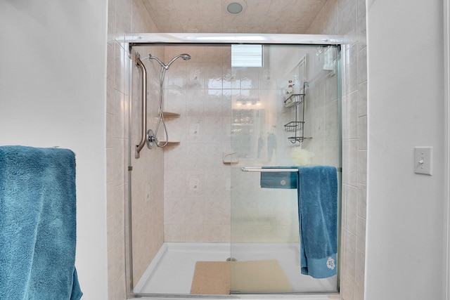 bathroom with a shower with shower door