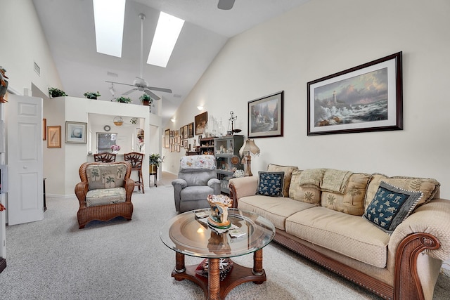 carpeted living room featuring high vaulted ceiling, ceiling fan, and a skylight