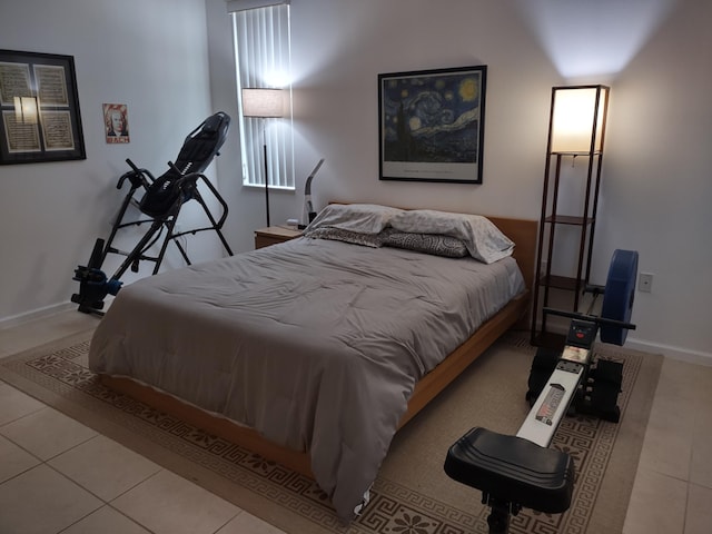 tiled bedroom featuring baseboards