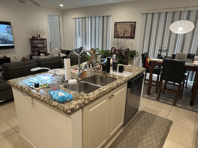 kitchen with dishwasher, sink, white cabinets, a kitchen island with sink, and light tile patterned floors