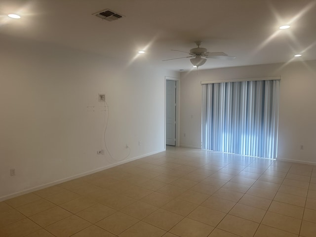 empty room featuring light tile patterned floors, recessed lighting, visible vents, ceiling fan, and baseboards