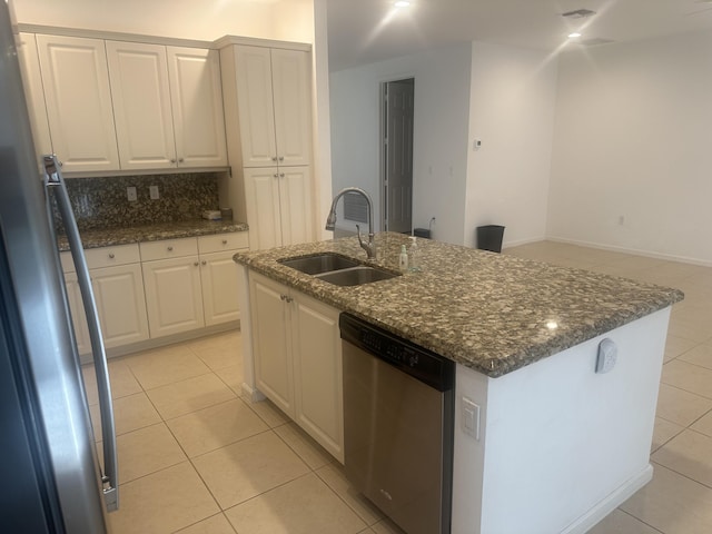 kitchen featuring white cabinets, stainless steel appliances, a sink, and light tile patterned flooring