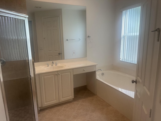 full bath with a garden tub, a shower stall, tile patterned flooring, and vanity