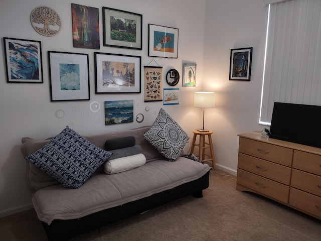 carpeted living area with baseboards