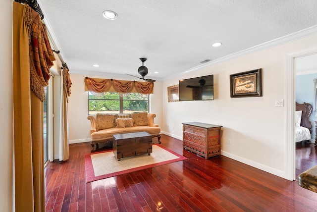 living room featuring crown molding, a textured ceiling, and dark hardwood / wood-style flooring