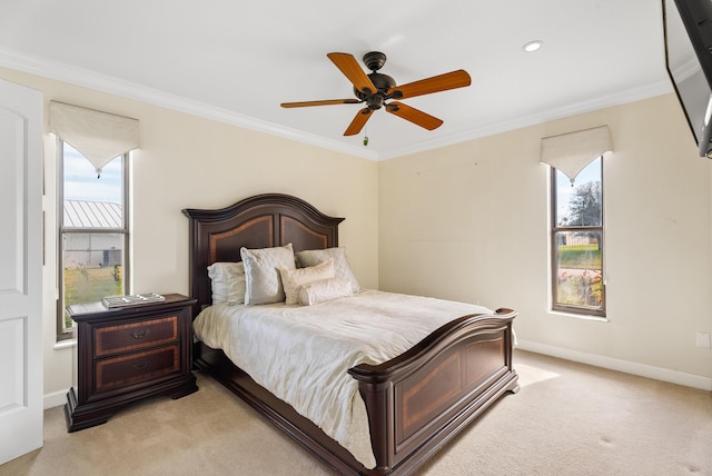 bedroom featuring multiple windows, crown molding, light carpet, and ceiling fan