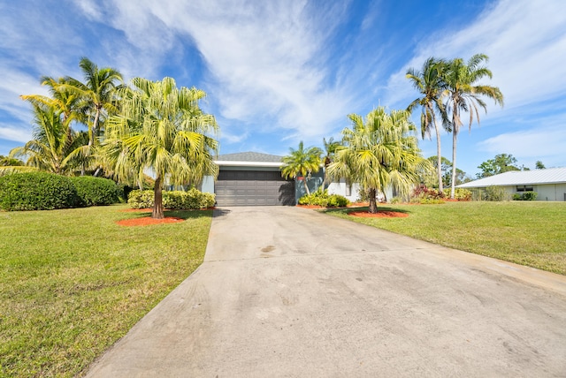 view of front of property featuring a garage and a front lawn