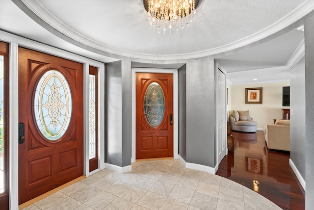 entryway featuring an inviting chandelier and ornamental molding